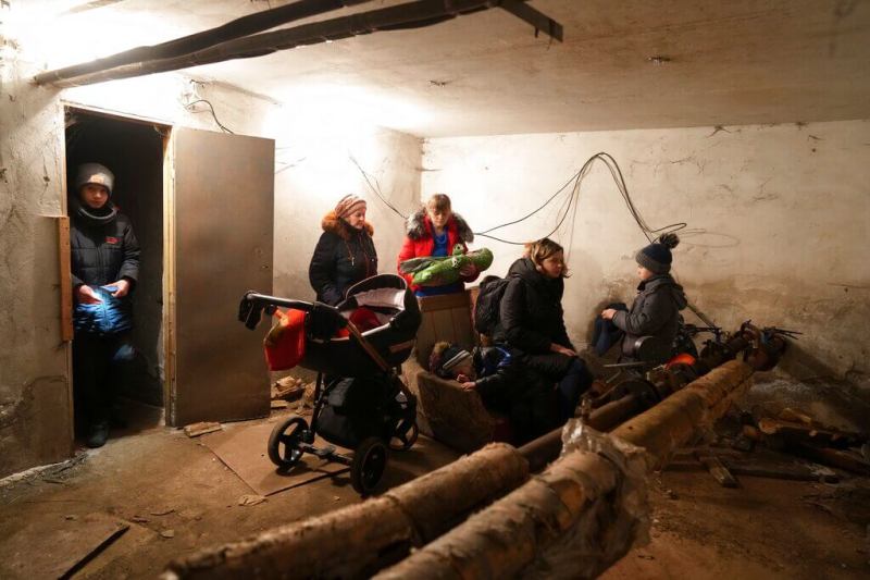 People gather in a shelter during Russian shelling, in Mariupol, Ukraine, Thursday, Feb. 24, 2022. Russia launched a wide-ranging attack on Ukraine on Thursday, hitting cities and bases with airstrikes or shelling, as civilians piled into trains and cars to flee. (AP Photo/Evgeniy Maloletka)