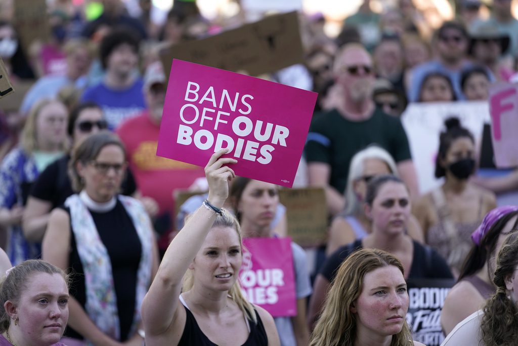 FILE - Abortion-rights protesters cheer at a rally following the United States Supreme Court's decision to overturn Roe v. Wade, federally protected right to abortion, outside the state capitol in Lansing, Mich., June 24, 2022. Voters in several states have used the citizen initiative process to protect access to abortion and other reproductive rights in the two years since the U.S. Supreme Court overturned a nationwide right to abortion. (AP Photo/Paul Sancya)