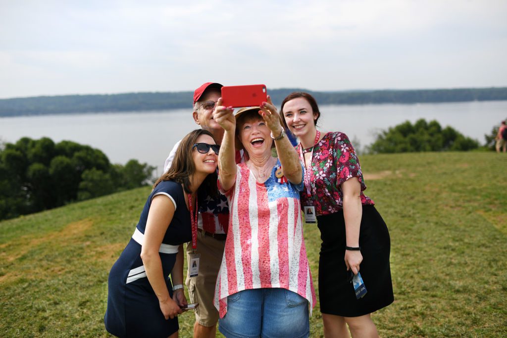 MOUNT VERNON, VA - JULY 04: Mount Vernon employees, Kara Hershorin, left, and Stephanie Breed, right, pose for a photo with Alan Foster, center, and his wife, Ann Foster during a Fourth of July celebration at Mount Vernon on Tuesday July 04, 2017 in Mount Vernon, VA. (Photo by Matt McClain/The Washington Post via Getty Images)