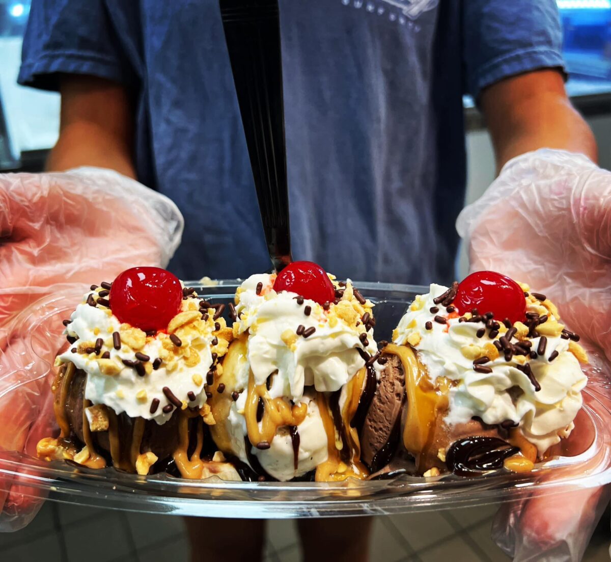 Man holding banana split.