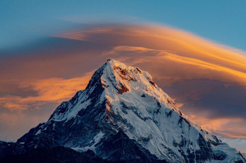 Everest mountain peak against sunset sky.
