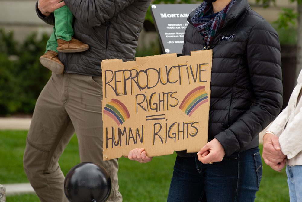 Person holding sign that reads, "Reproductive Rights Are Human Rights."