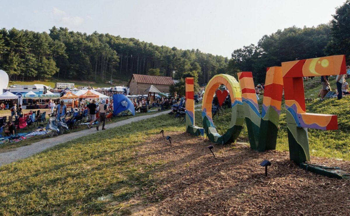 Vibrant festival atmosphere with attendees enjoying live music and art