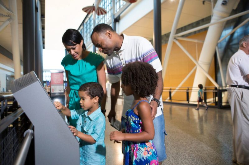 a family studies a sign in preparation to go stargazing