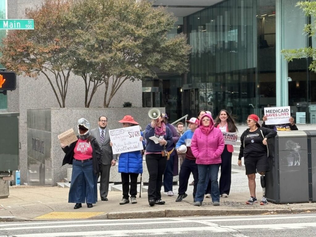 Demonstrators on a downtown Richmond street corner calling on Republicans to support affordable health care policies.