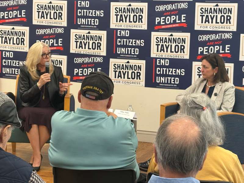 Democrat Shannon Taylor speaks with End Citizens United president Tiffany Muller before a room full of supporters