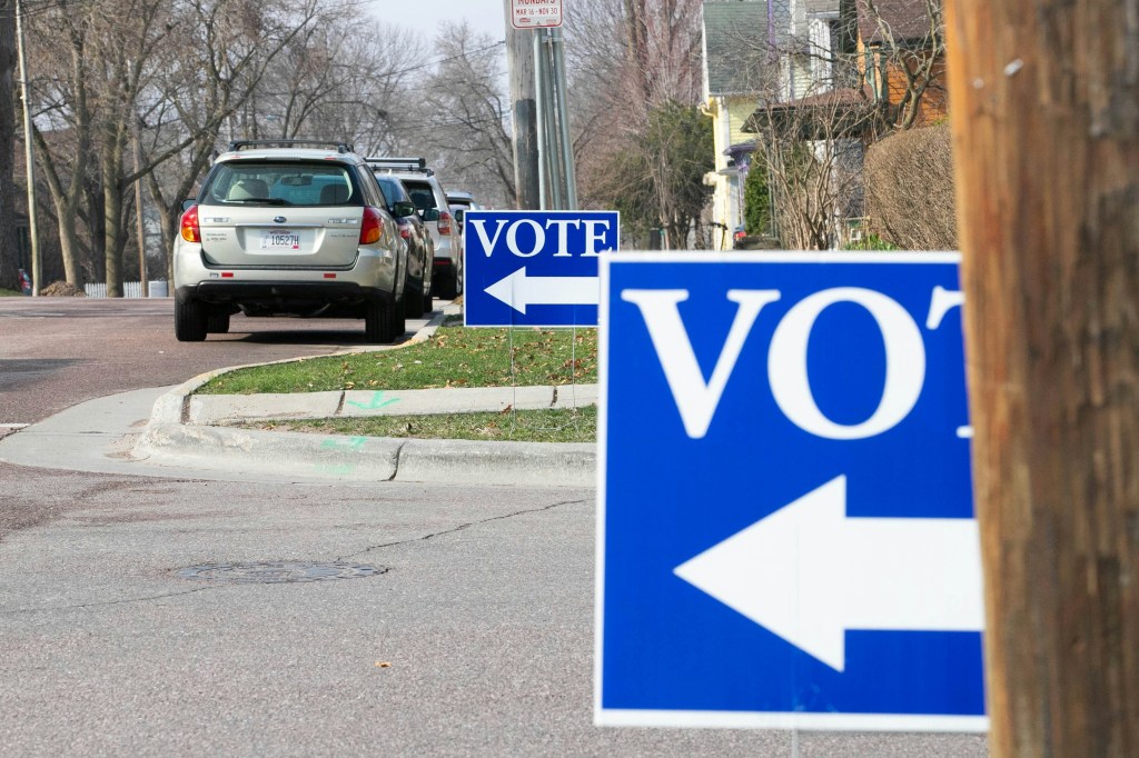 Carpool and rideshare cars line up as voters cast their ballots at the polls.